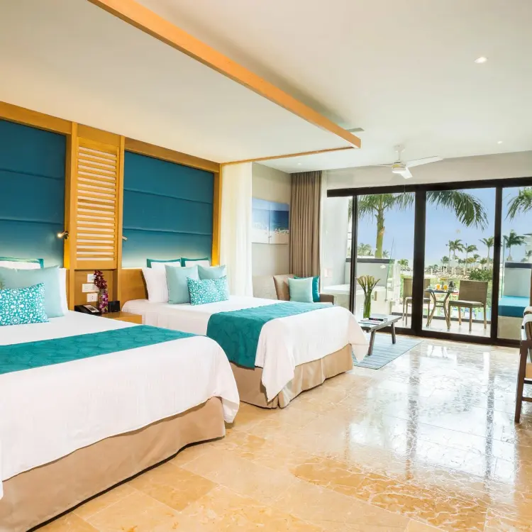 Dreams Playa Mujeres guest room with two beds and a balcony, Cancun