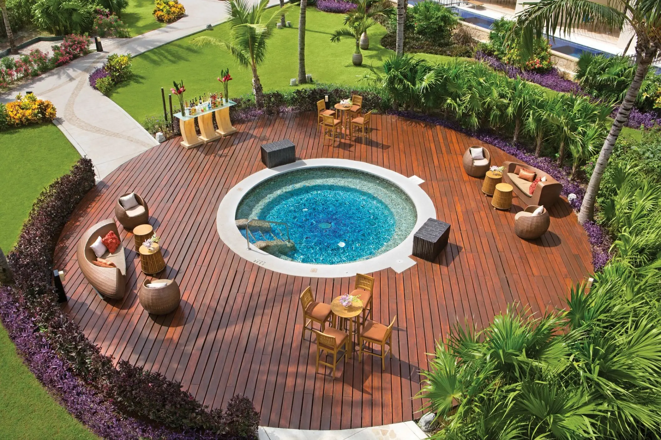 Circular wooden terrace with whirlpool and lounge seating at Dreams Riviera Cancun, Riviera Maya