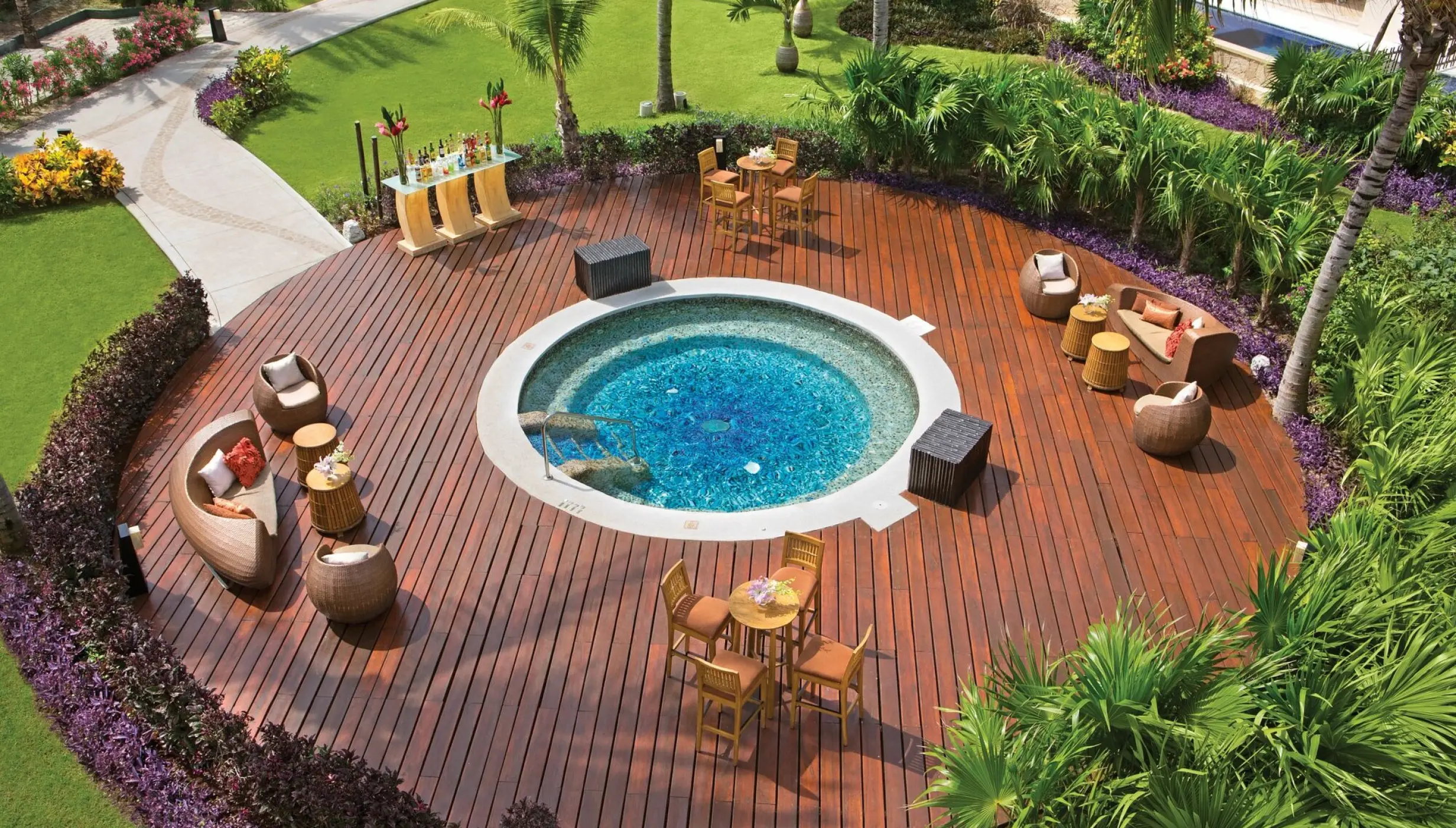 Circular wooden terrace with whirlpool and lounge seating at Dreams Riviera Cancun, Riviera Maya