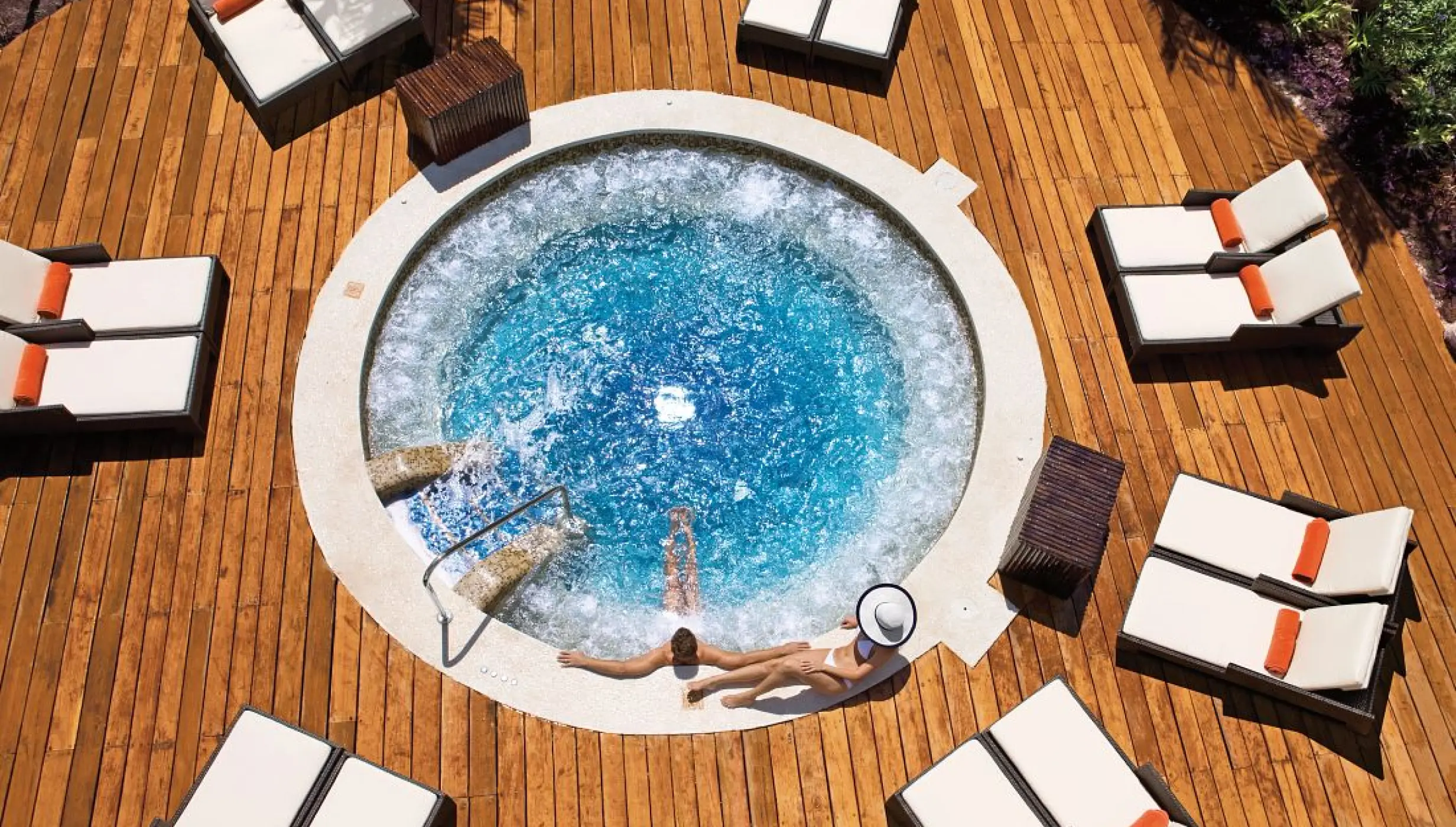 Overhead view of a couple in an outdoor whirlpool at Dreams Riviera Cancun, Riviera Maya
