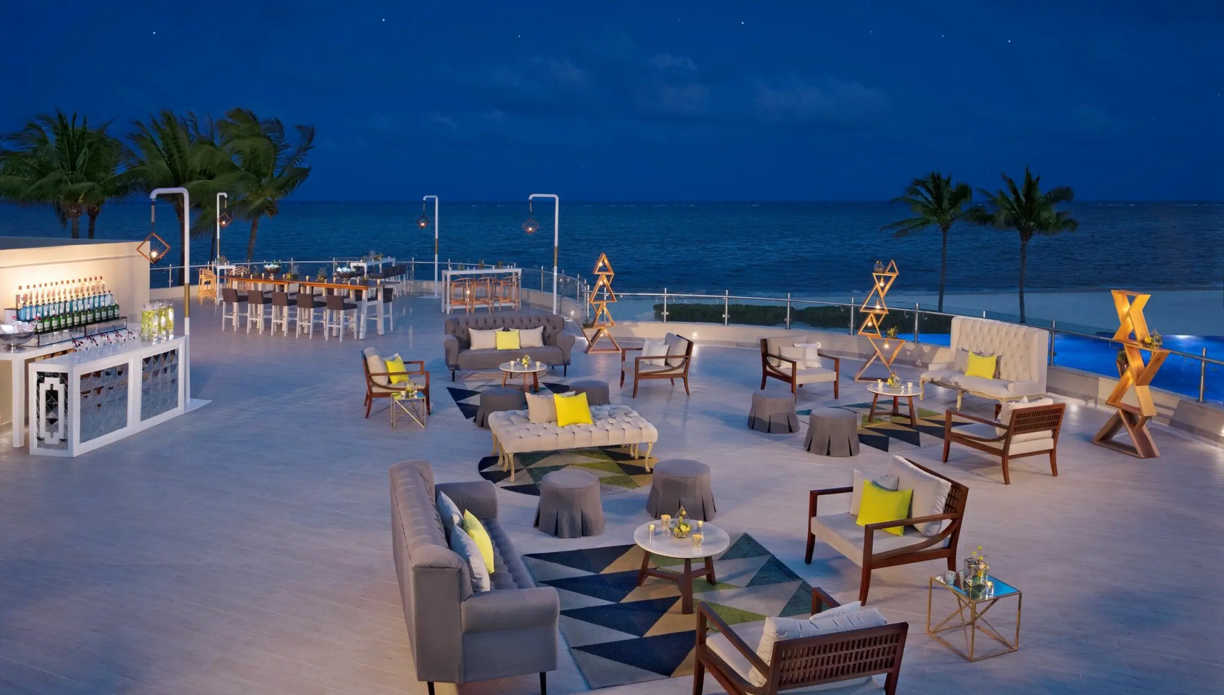 Terrace wedding reception with lounge seating at night at Dreams Riviera Cancun, Riviera Maya