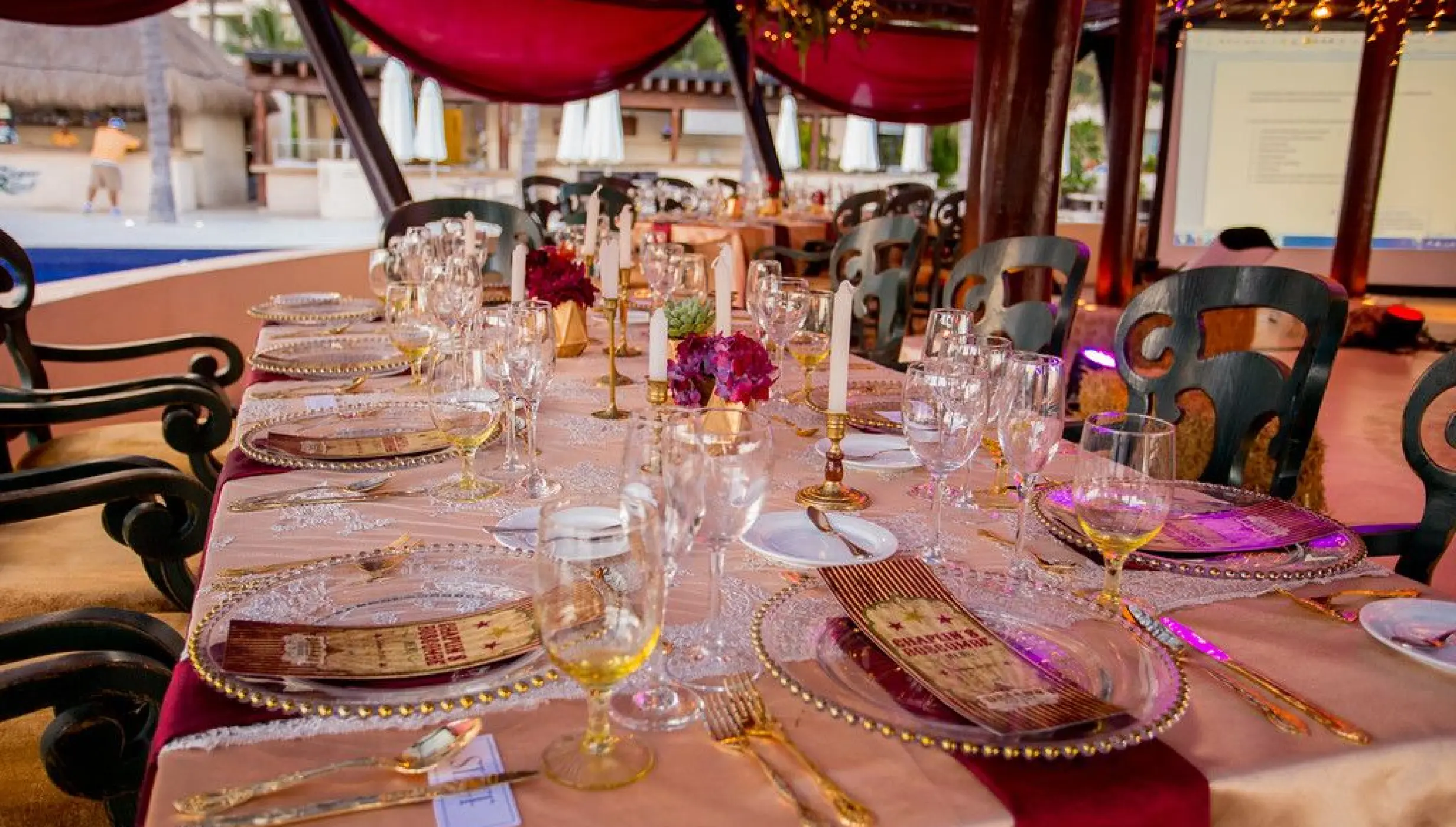Oceana Terrace wedding reception table with gold decor and red accents at Dreams Riviera Cancun, Riviera Maya
