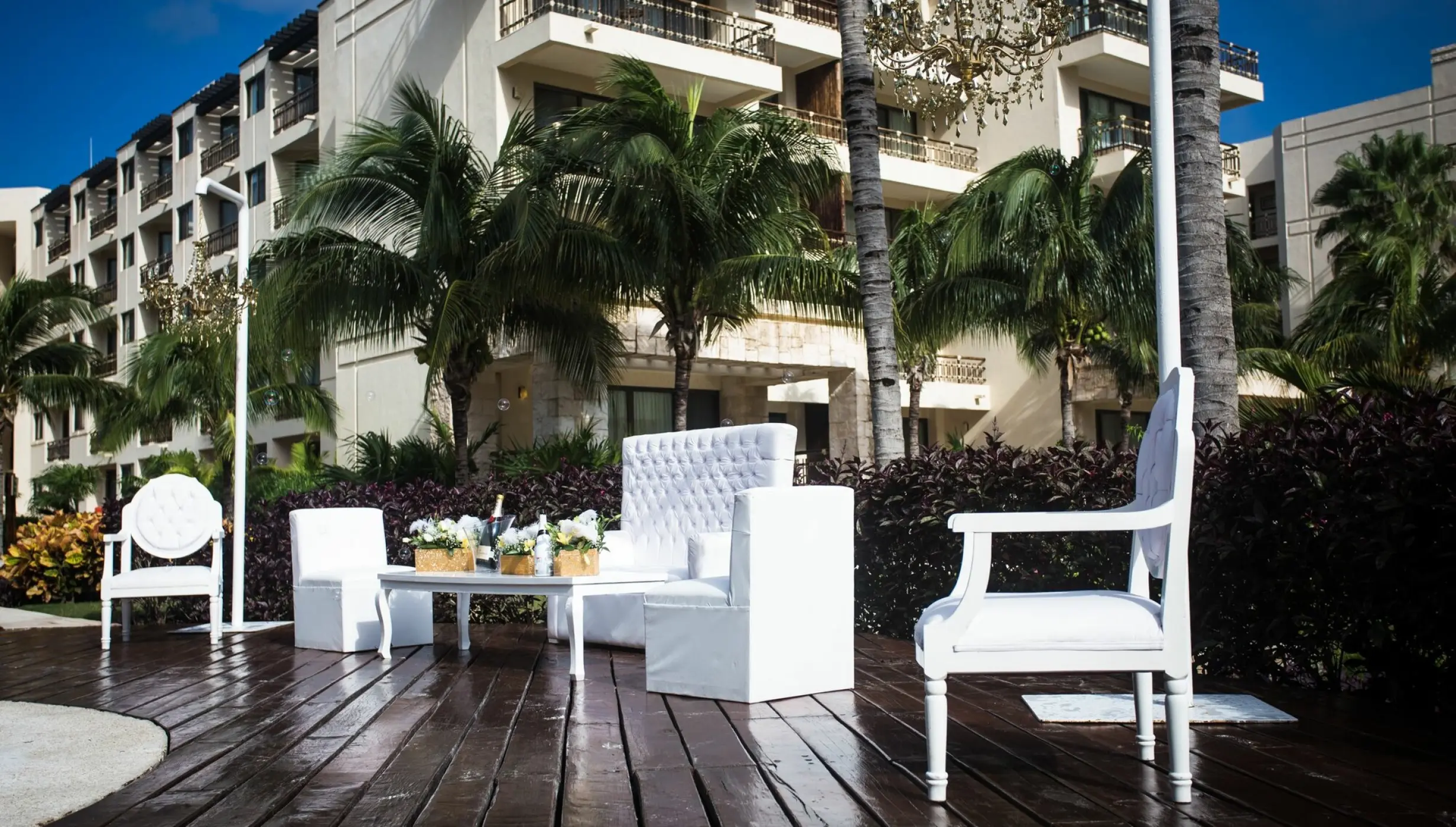 White lounge furniture on a wooden deck at Dreams Riviera Cancun, Riviera Maya