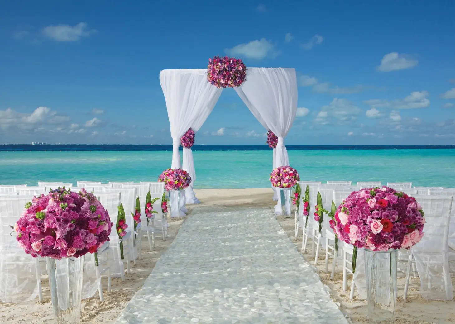 Dreams Sands Cancun beach wedding venue with chair and altar