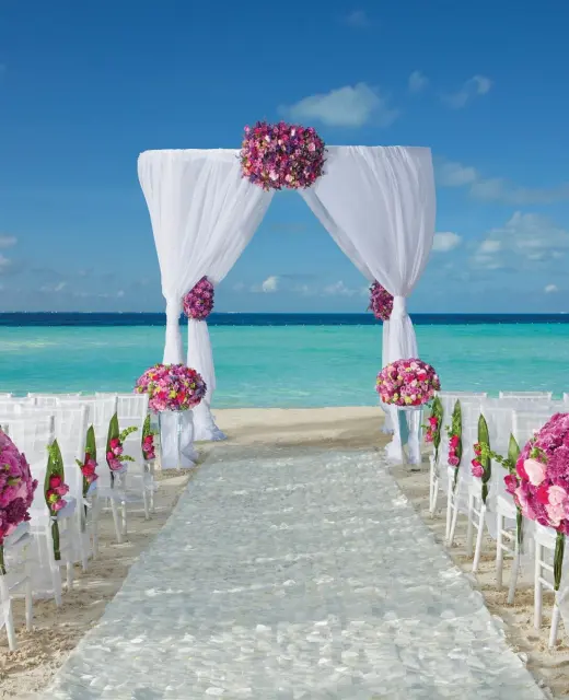 Dreams Sands Cancun beach wedding venue with chair and altar