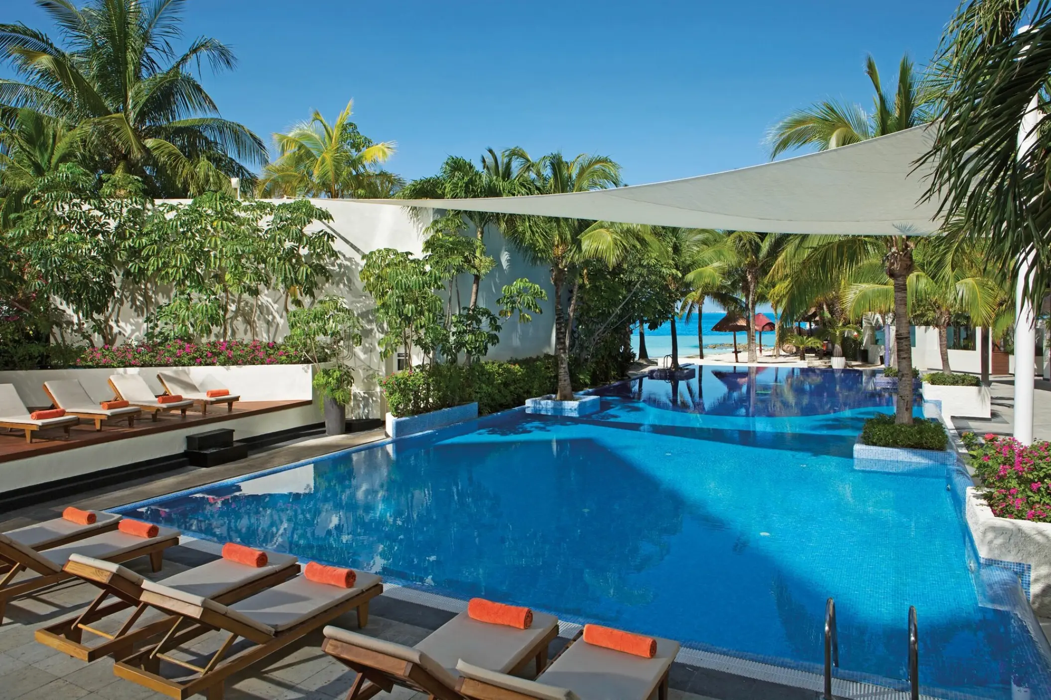Dreams Sands Cancun infinity pool with lounge chairs and shade sails, Cancun
