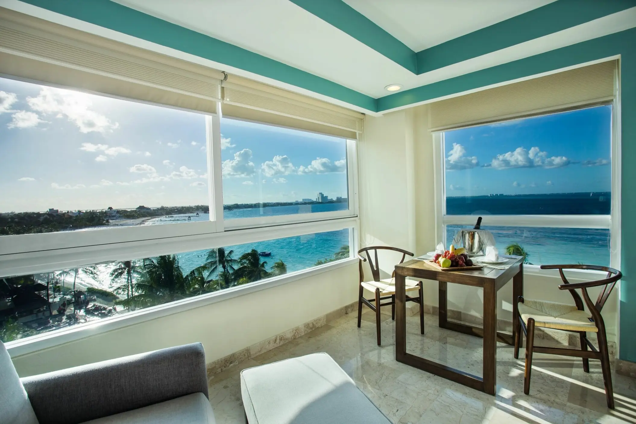 Dreams Sands Cancun guest room with a dining area and ocean views, Cancun