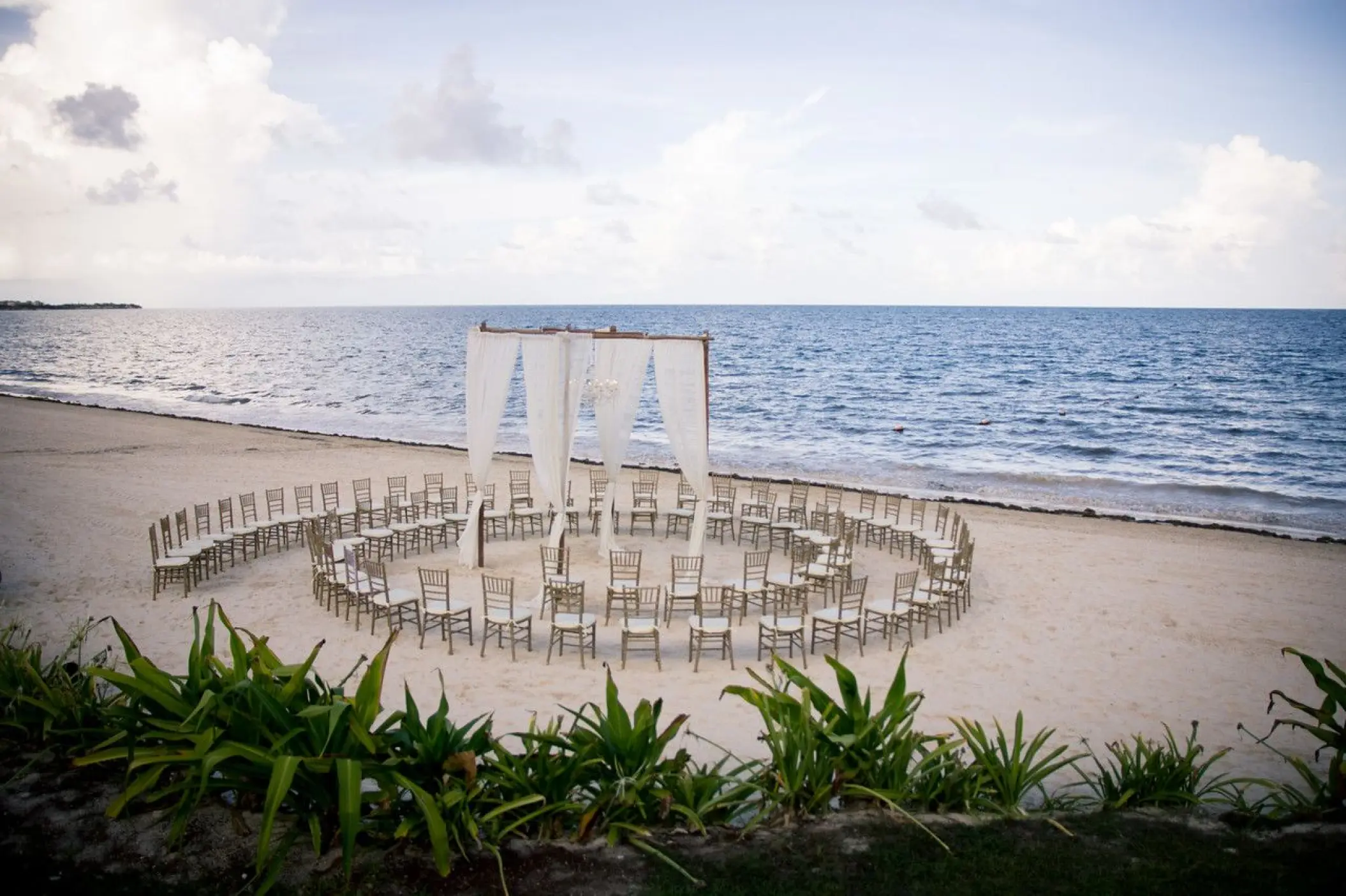 Beachfront wedding ceremony with circular seating at Dreams Sapphire, Riviera Maya