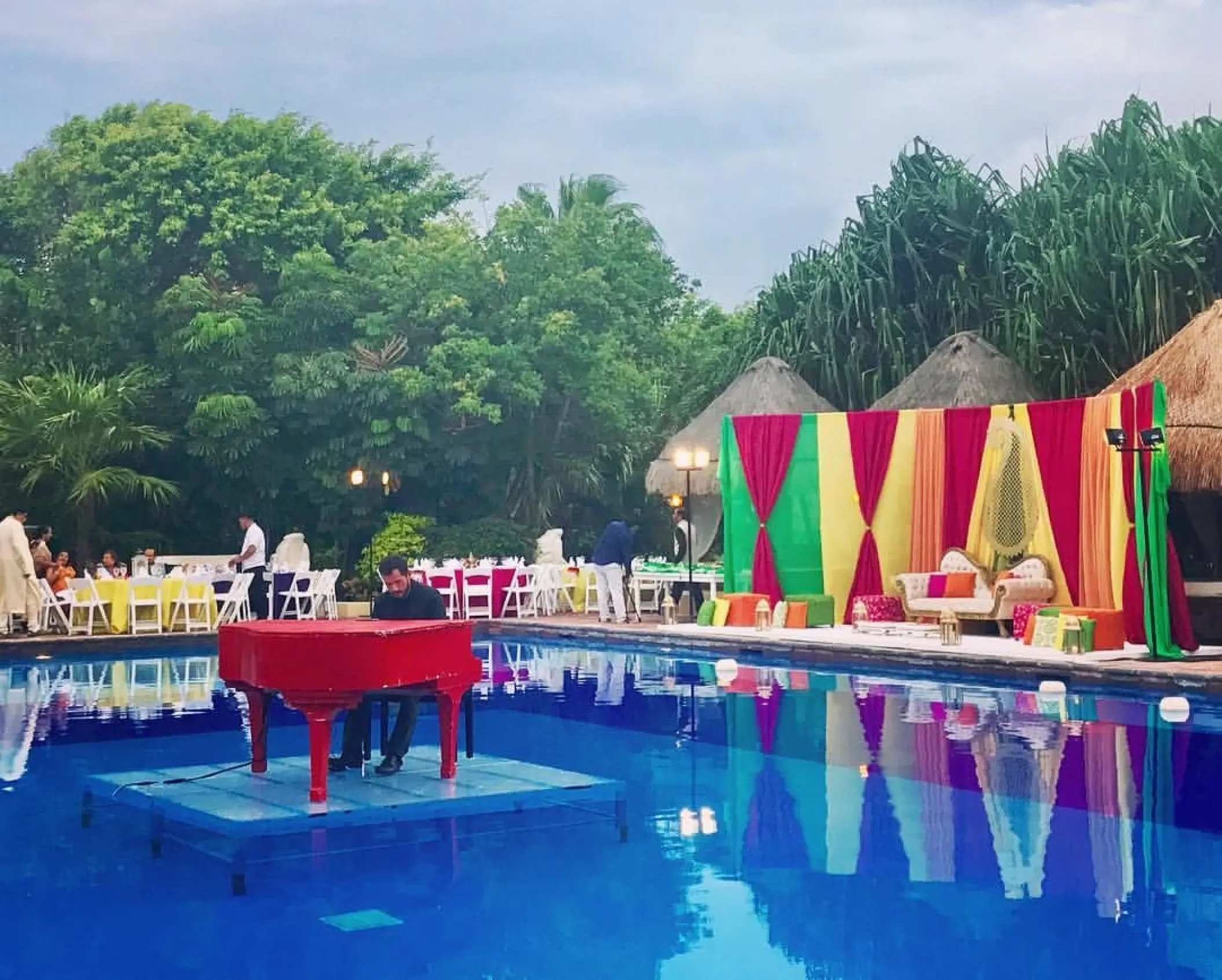 Red piano on a pool platform for a wedding reception at Dreams Sapphire, Riviera Maya
