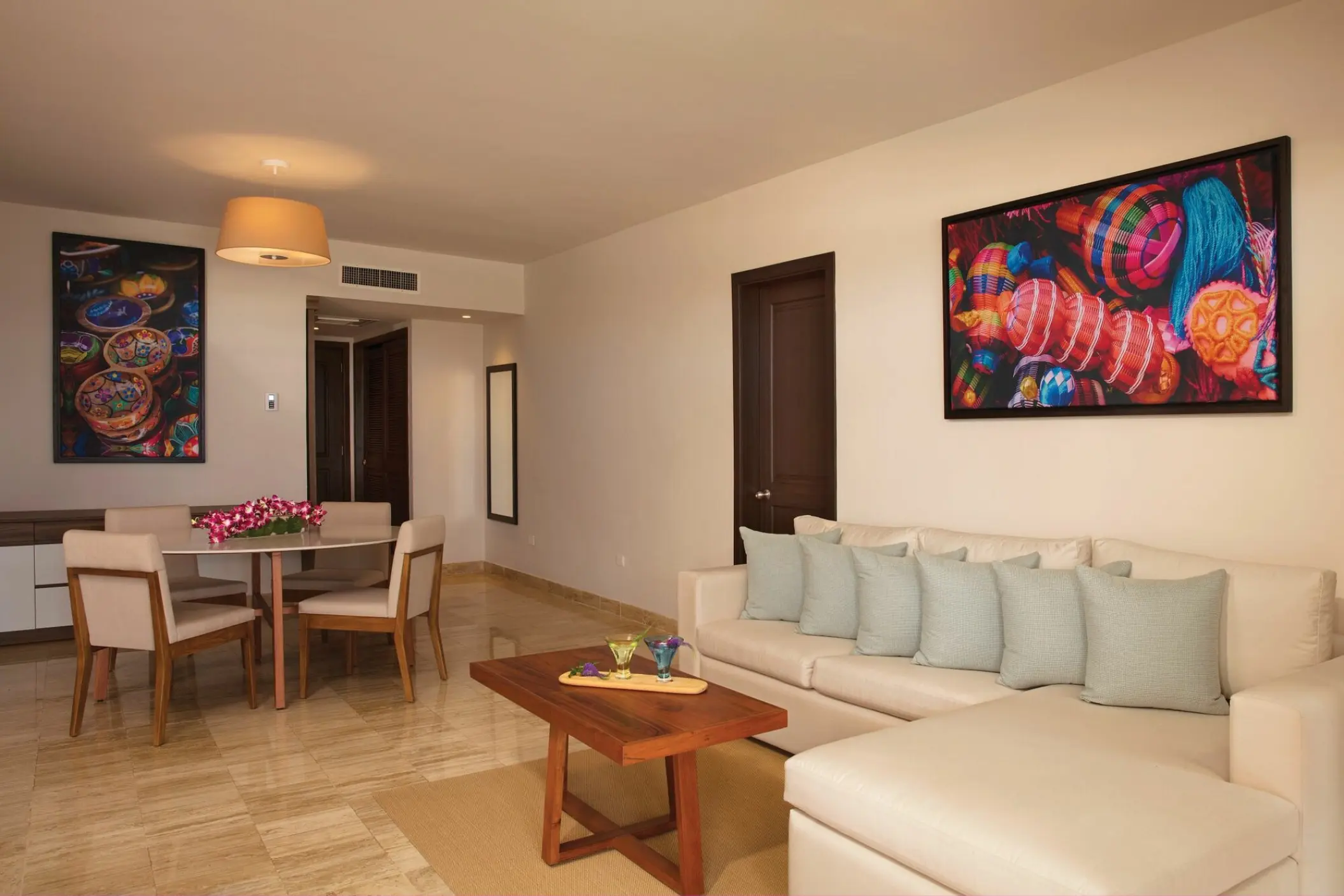 Master suite living area with sofa and dining table at Dreams Sapphire, Riviera Maya