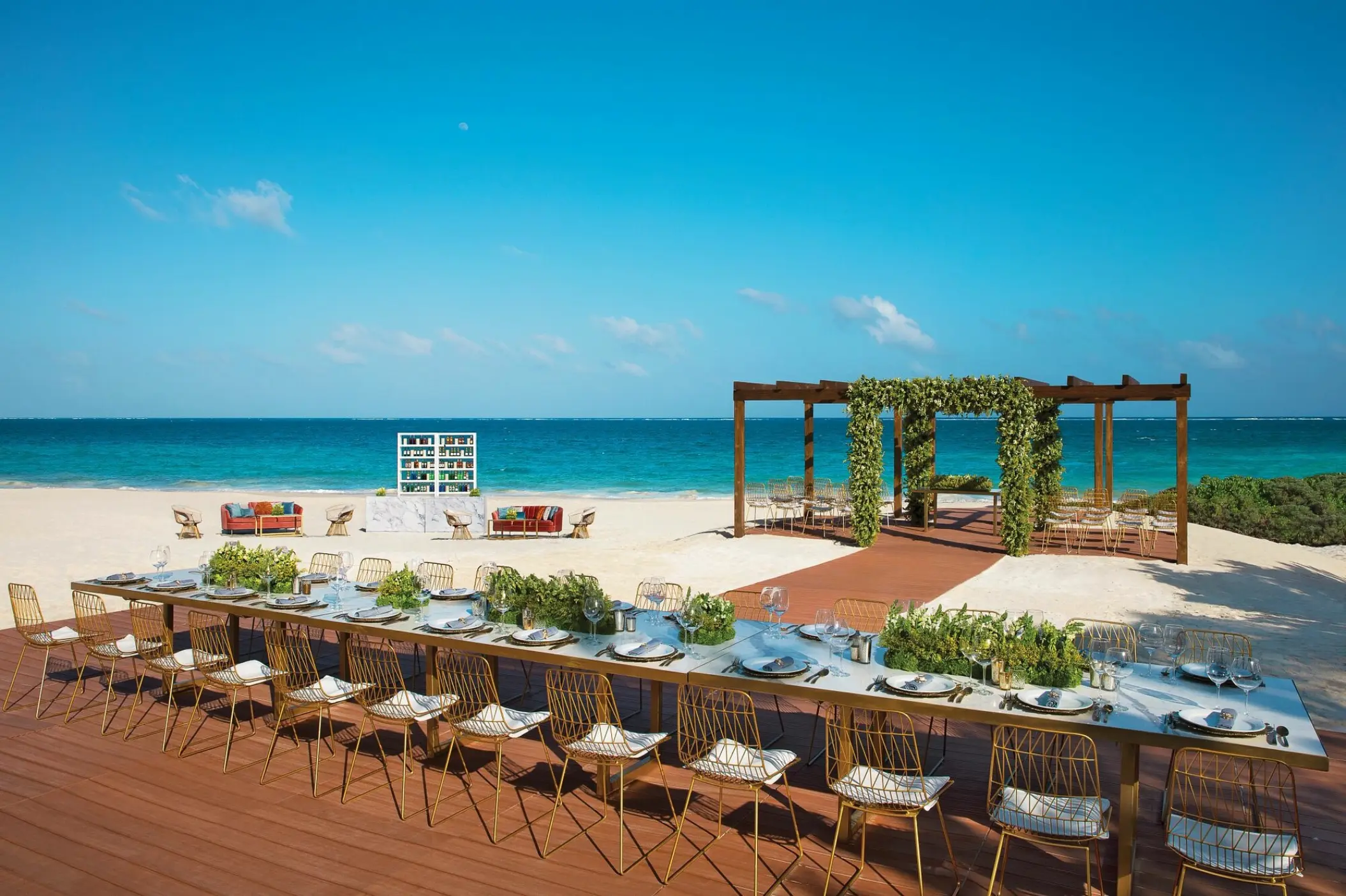 Beachfront wedding reception setup on a wooden terrace at Dreams Sapphire, Riviera Maya