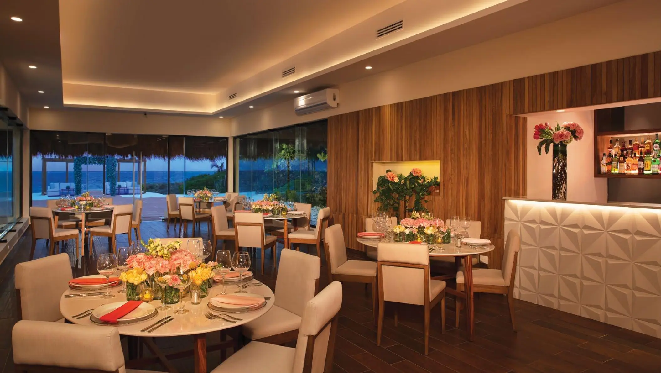 Indoor wedding reception tables and bar at Dreams Sapphire, Riviera Maya