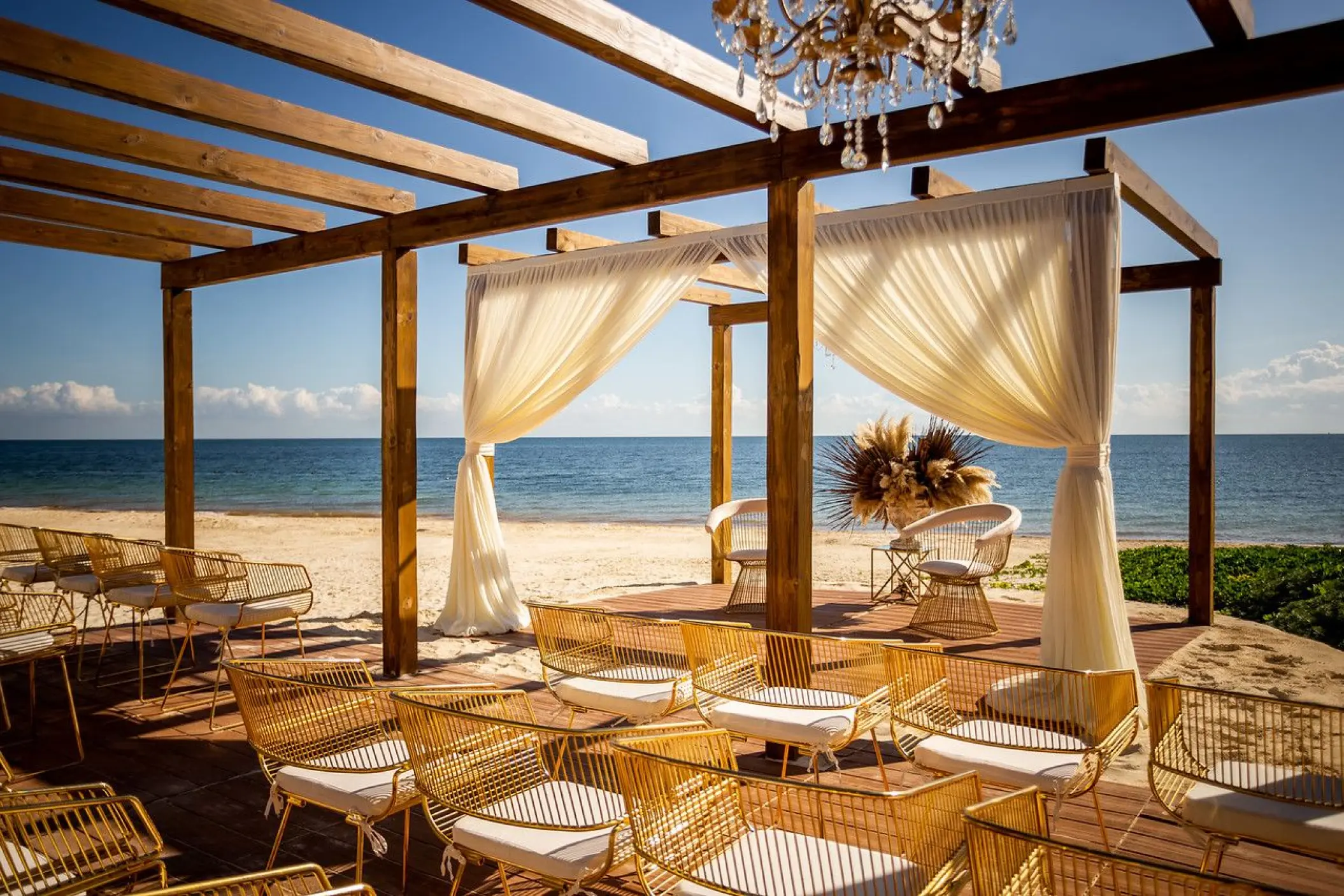Vista del Mar terrace wedding ceremony setup under a wooden pergola at Dreams Sapphire, Riviera Maya