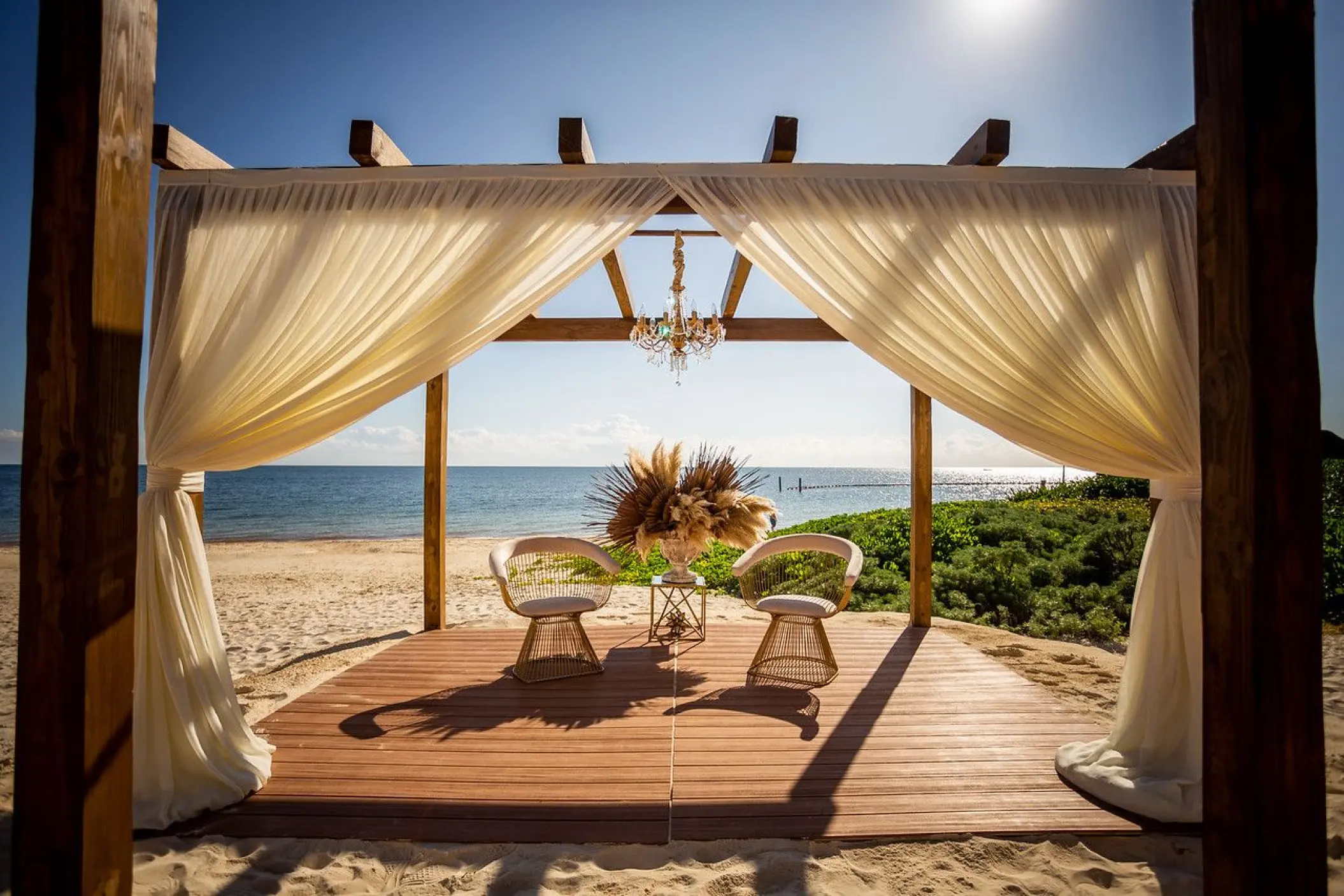 Vista del Mar pergola wedding ceremony setup on the beach at Dreams Sapphire, Riviera Maya