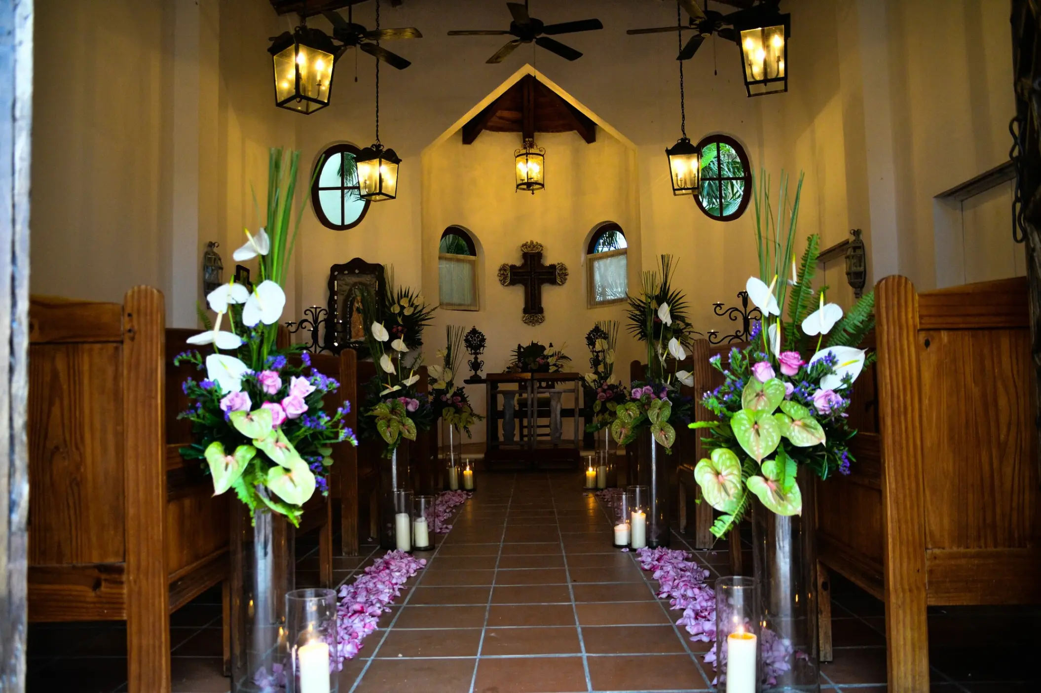 Chapel wedding ceremony venue with floral arrangements and candlelit aisle at Dreams Tulum, Tulum