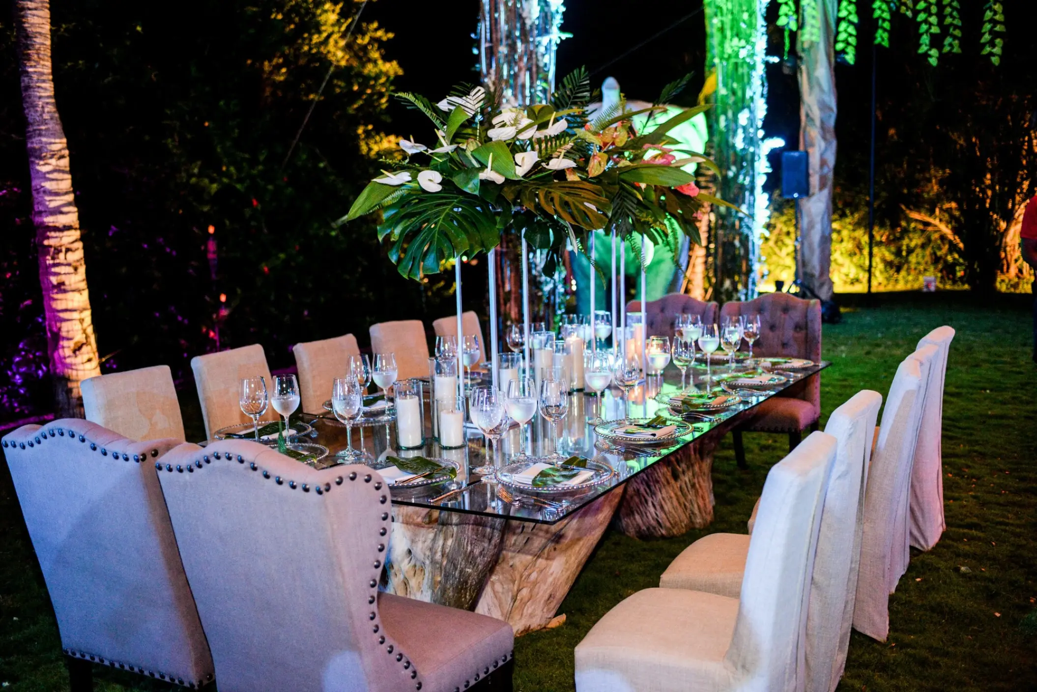 Evening wedding reception dinner setup with tropical centerpieces at Dreams Tulum, Tulum