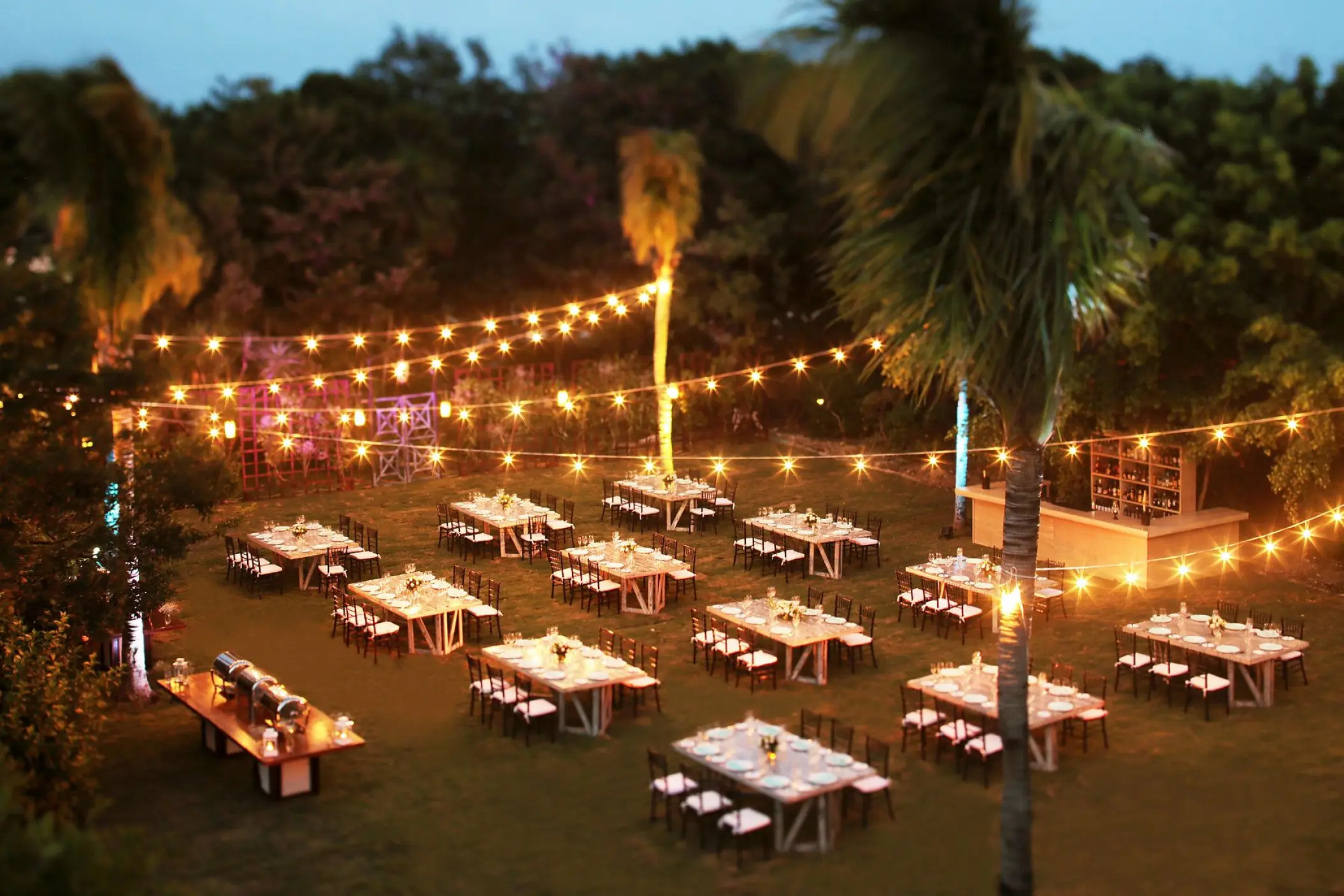 Garden wedding reception setup with string lights at Dreams Tulum