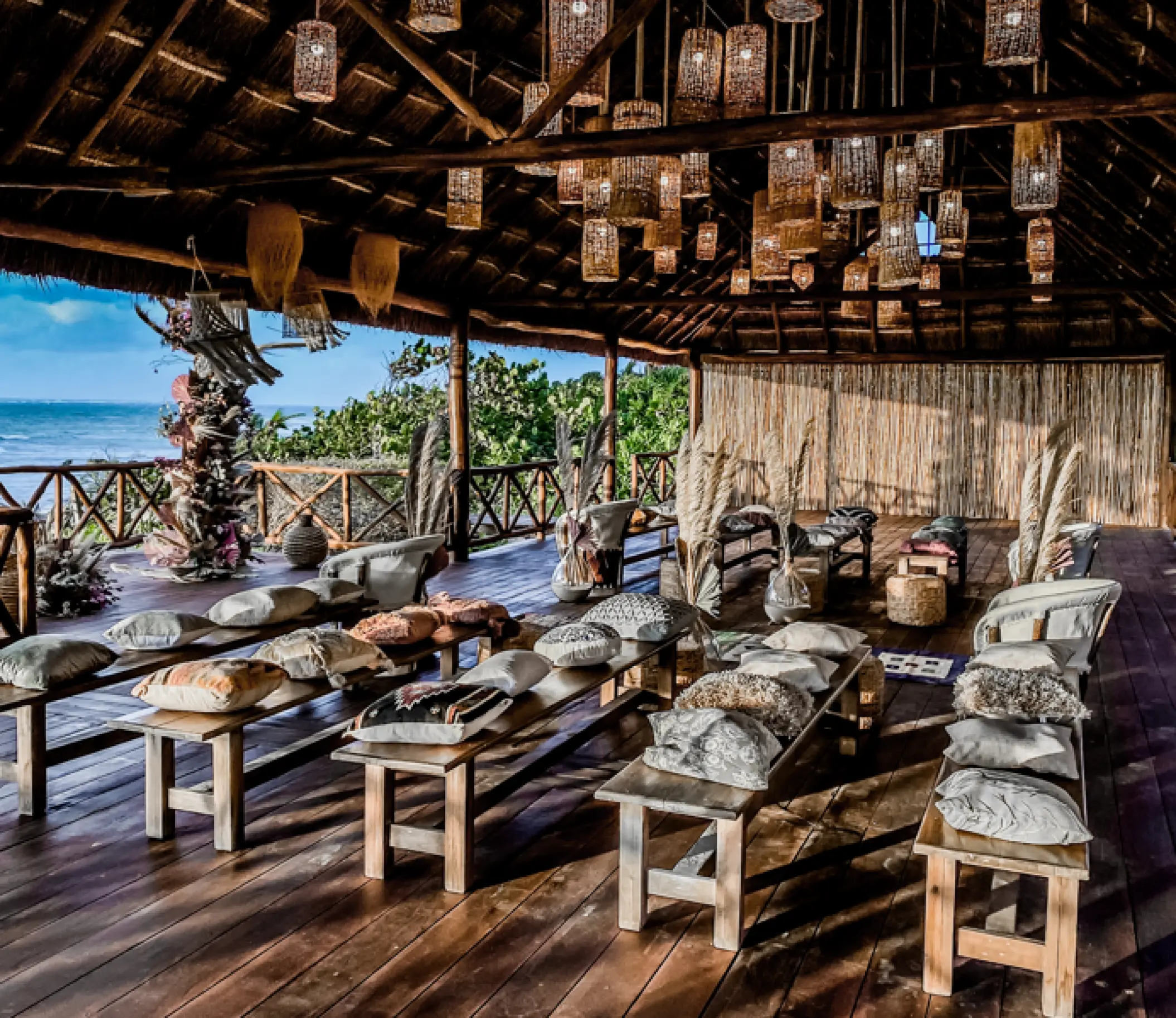 Boho-style wedding ceremony setup inside an oceanfront palapa at Dreams Tulum, Tulum