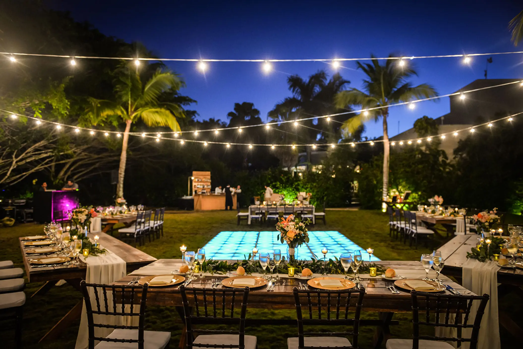 Garden wedding reception with glowing dance floor and string lights at Dreams Tulum, Tulum