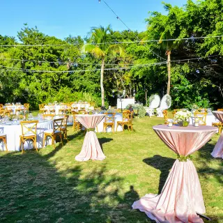 Garden wedding reception with round tables and pink cocktail linens at Dreams Tulum
