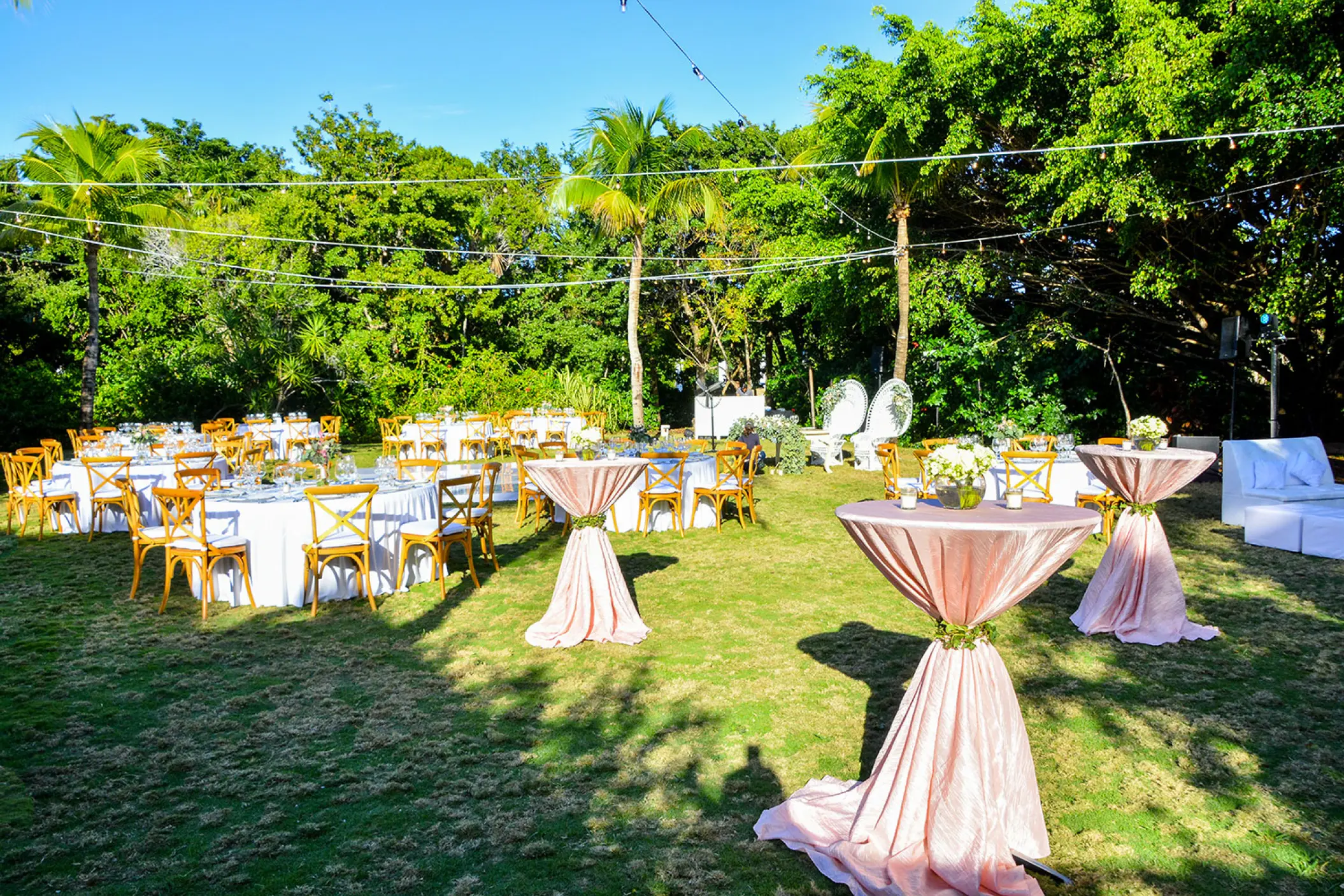 Garden wedding reception with round tables and pink cocktail linens at Dreams Tulum