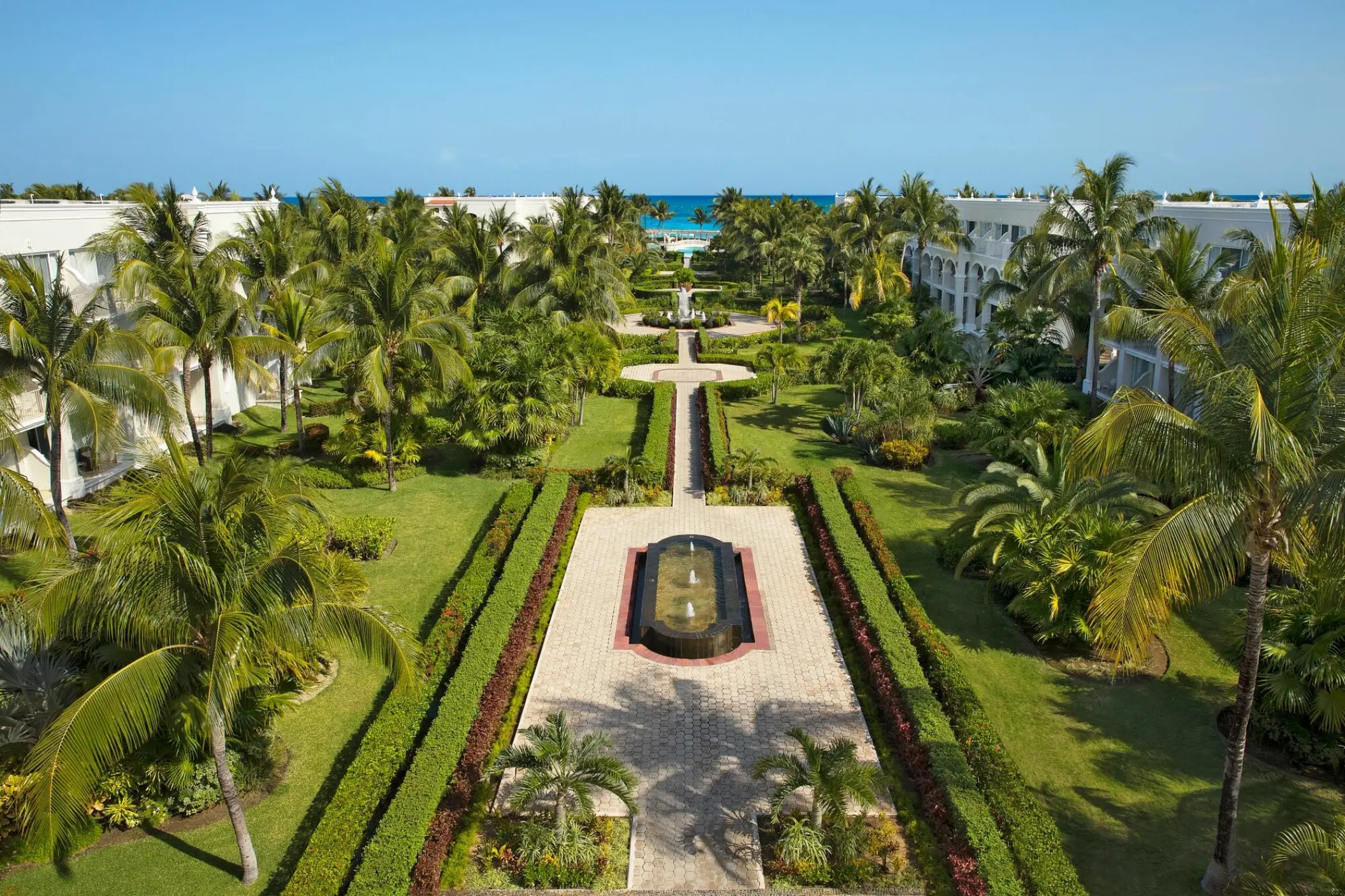 Lush tropical gardens and fountain walkways at Dreams Tulum, Tulum