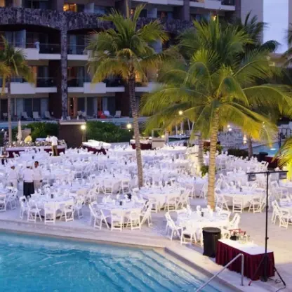 Evening wedding reception setup by the pool at Dreams Vallarta Bay, Puerto Vallarta