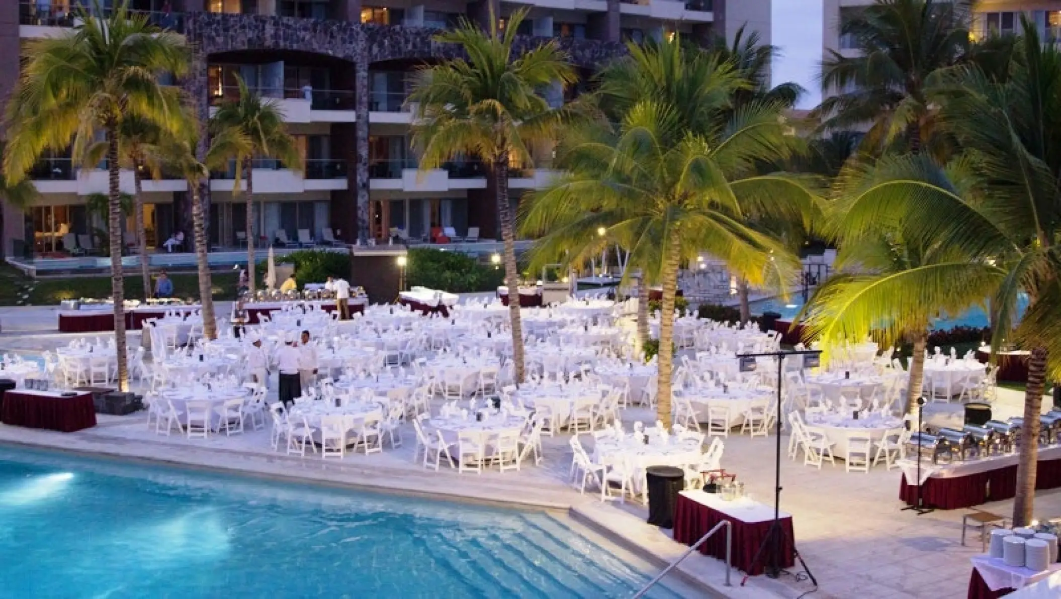 Evening wedding reception setup by the pool at Dreams Vallarta Bay, Puerto Vallarta