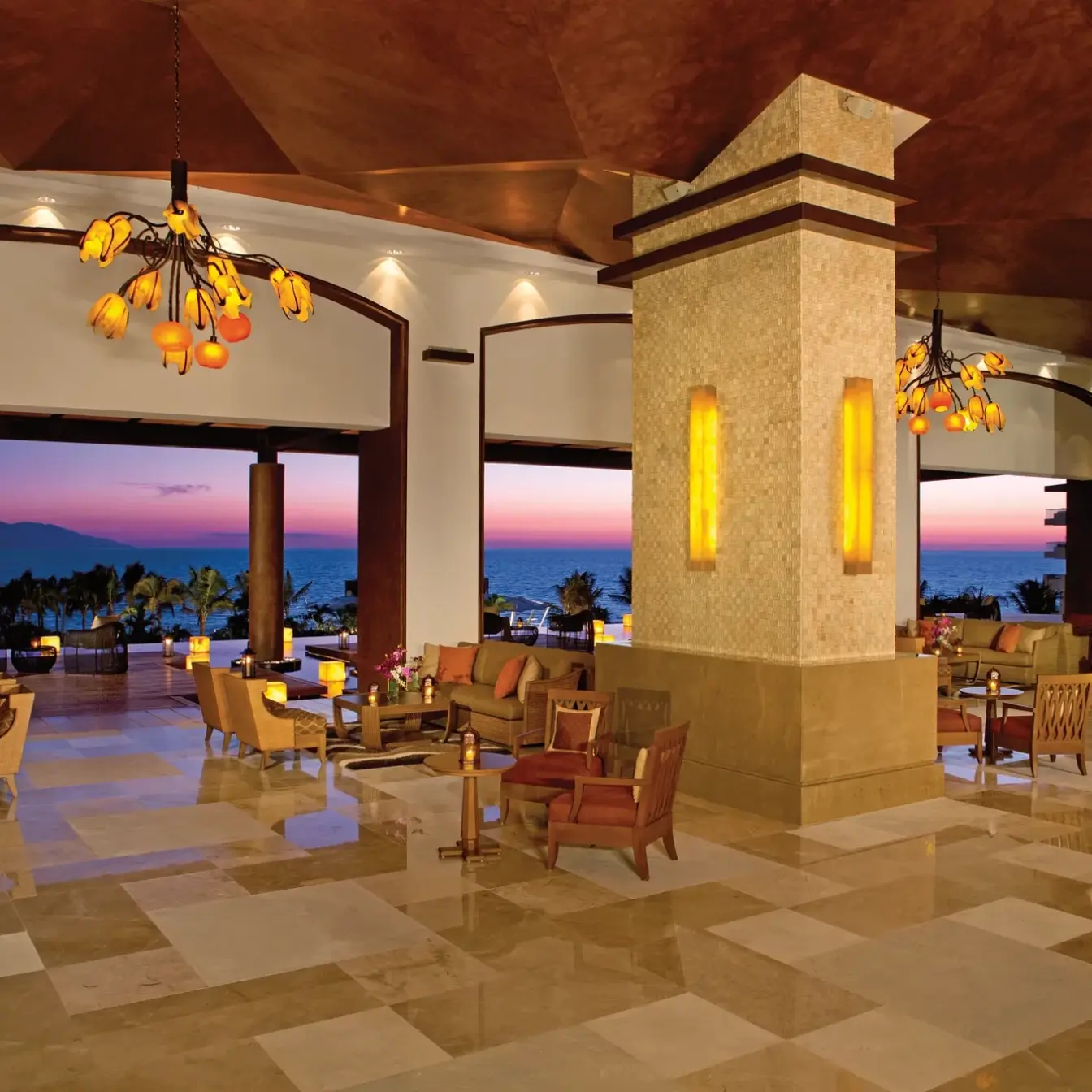 Open-air lobby lounge at Dreams Vallarta Bay overlooking the ocean at sunset, Puerto Vallarta