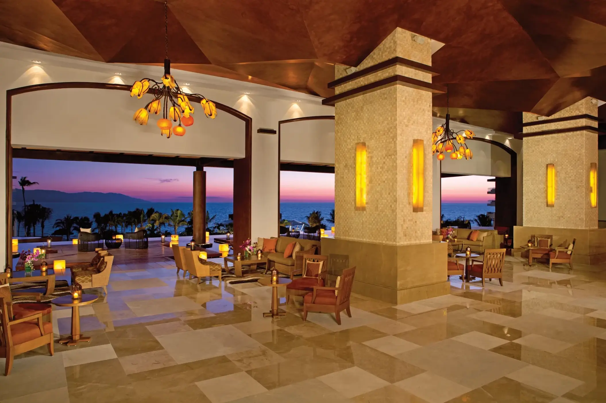 Open-air lobby lounge at Dreams Vallarta Bay overlooking the ocean at sunset, Puerto Vallarta