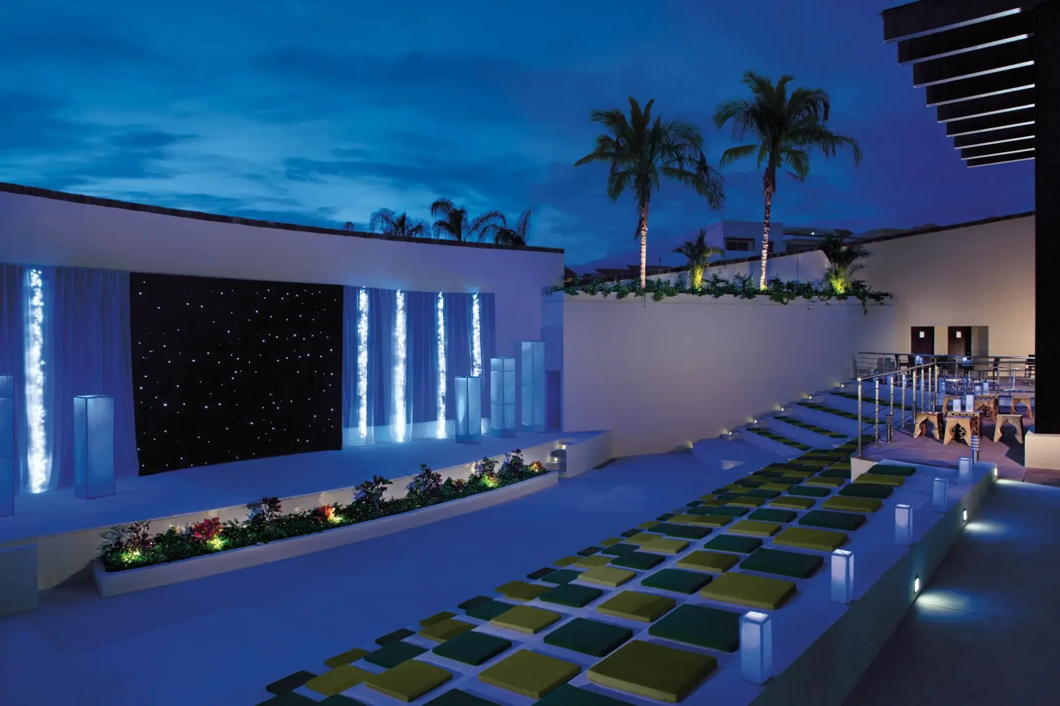 Open-air theater with stage lighting and tiered seating at Dreams Vallarta Bay, Puerto Vallarta