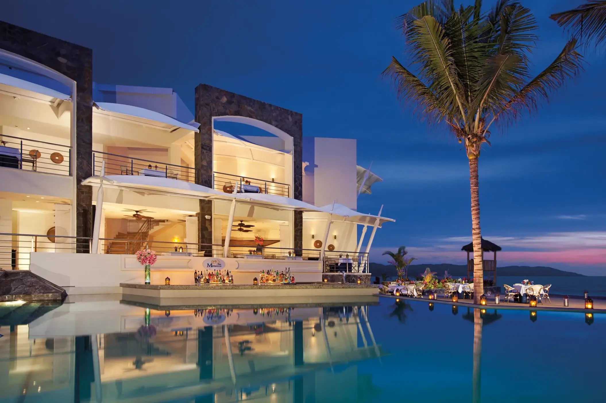 Dreams Vallarta Bay outdoor pool bar and restaurant at dusk, Puerto Vallarta