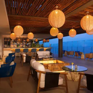 Rooftop lounge with hanging lanterns and ocean views at Dreams Vista Cancun, Cancun