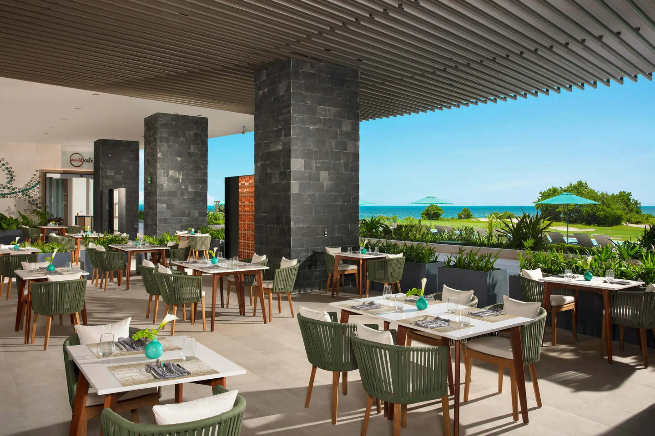 Outdoor restaurant terrace with ocean views at Dreams Vista Cancun
