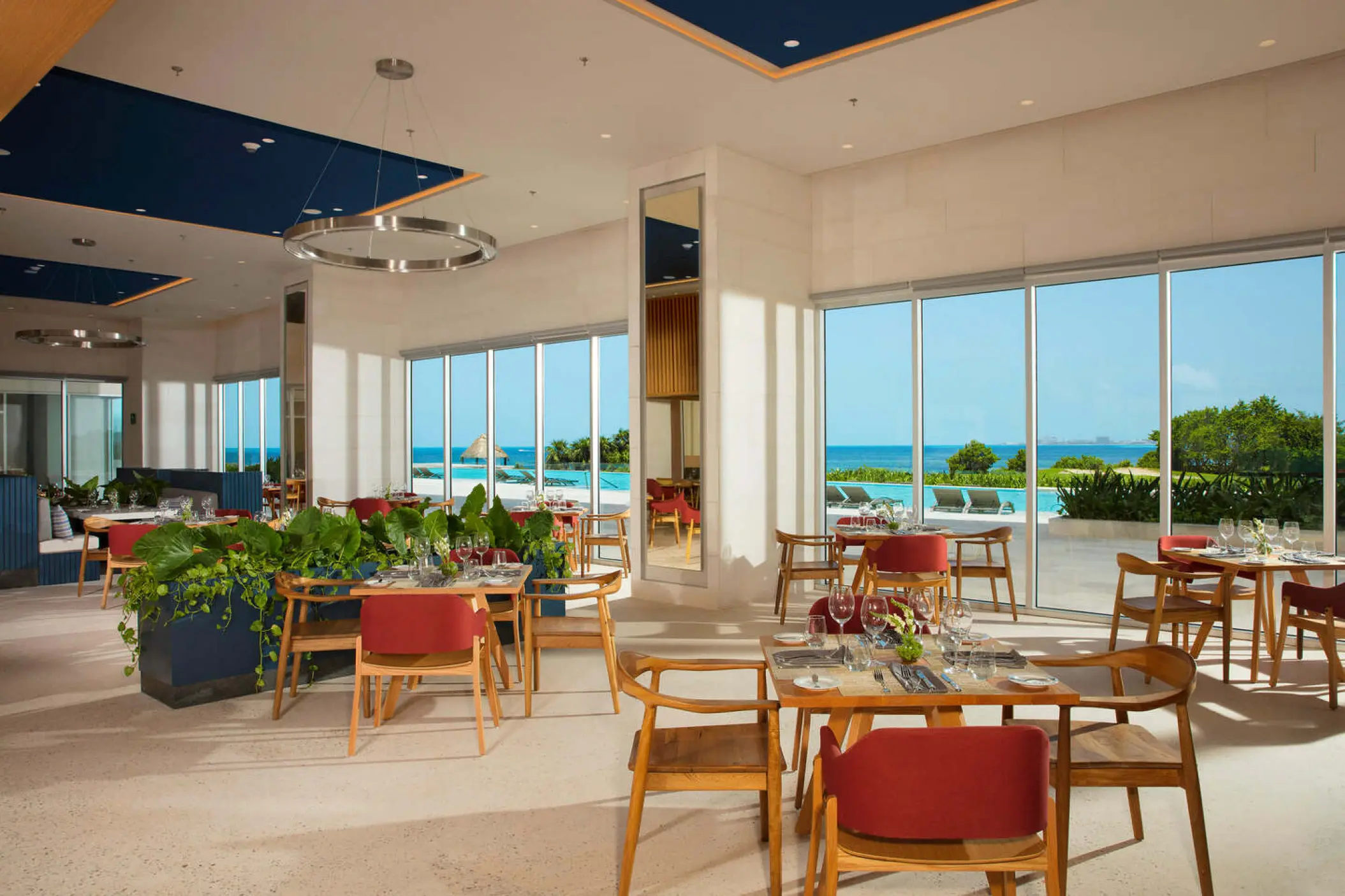 Indoor restaurant dining area with ocean views at Dreams Vista Cancun