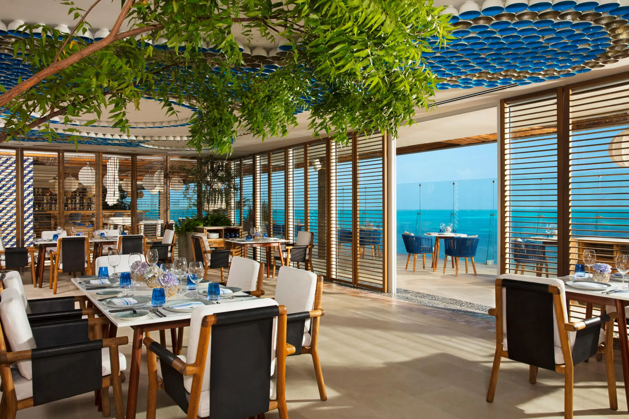 Open-air restaurant with turquoise ocean views at Dreams Vista Cancun