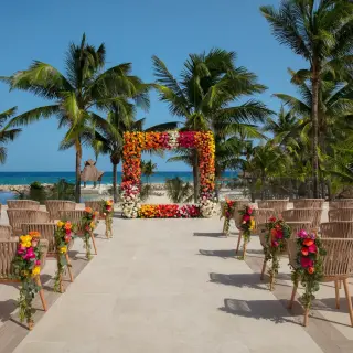 Floral ceremony arch on a terrace with ocean views at Dreams Aventuras, Riviera Maya