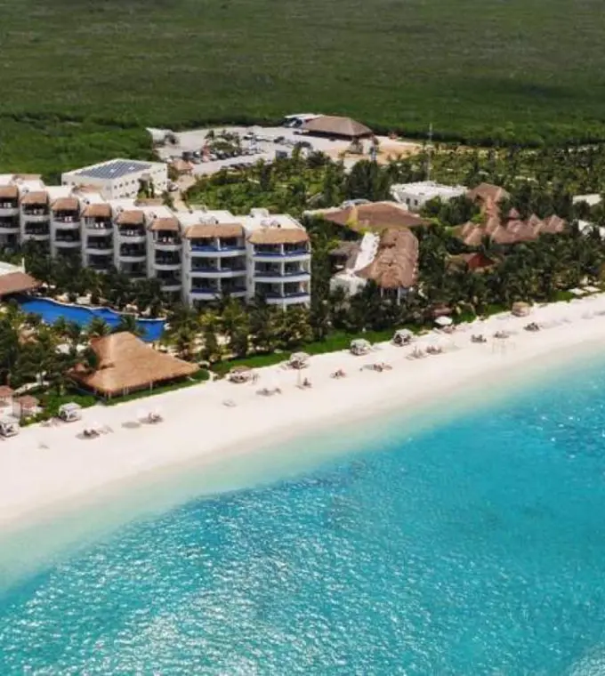 Aerial view of the beachfront suites and white sand at El Dorado Maroma, Riviera Maya