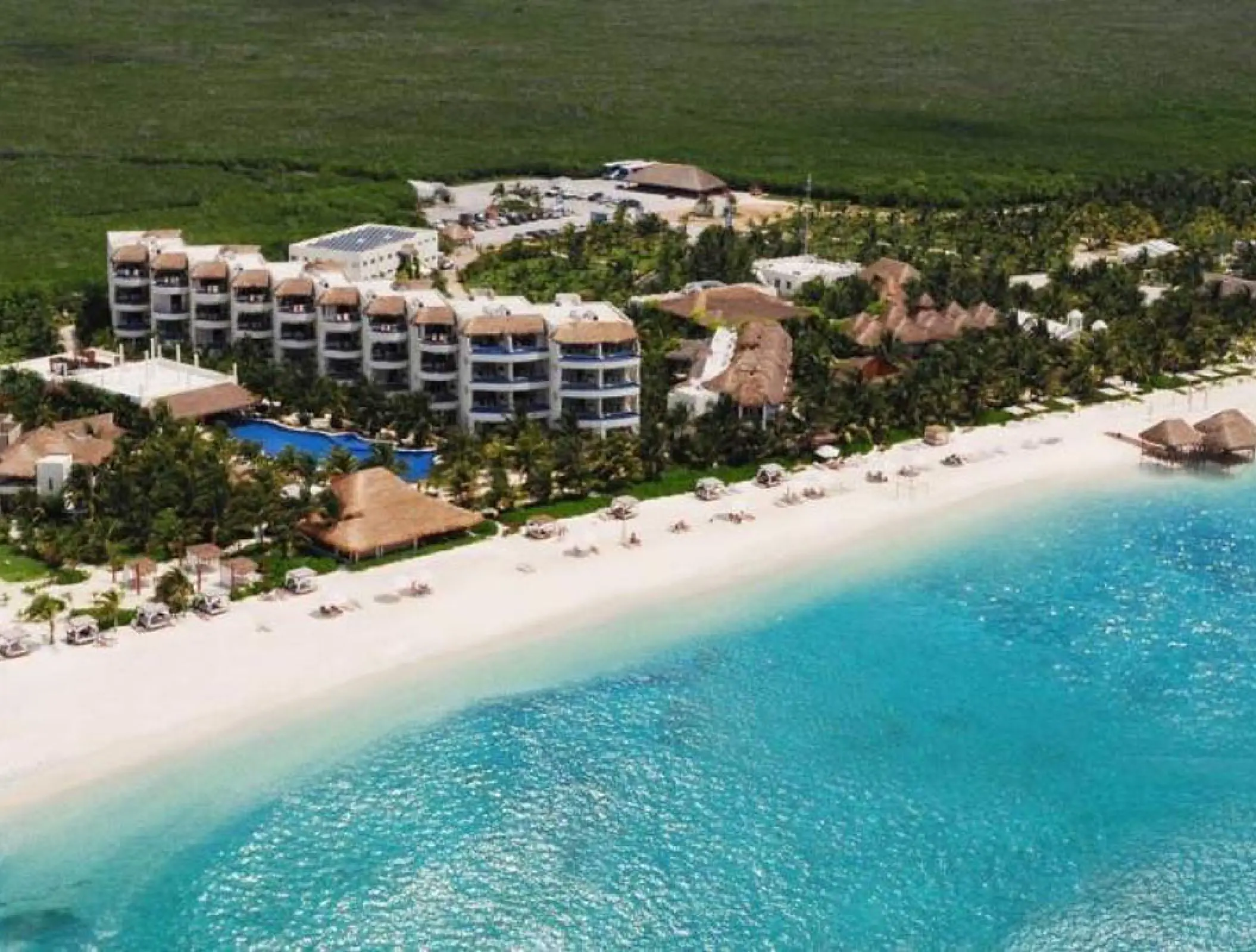 Aerial view of the beachfront suites and white sand at El Dorado Maroma, Riviera Maya