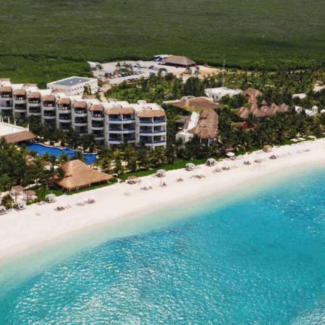 Aerial view of the beachfront suites and white sand at El Dorado Maroma, Riviera Maya