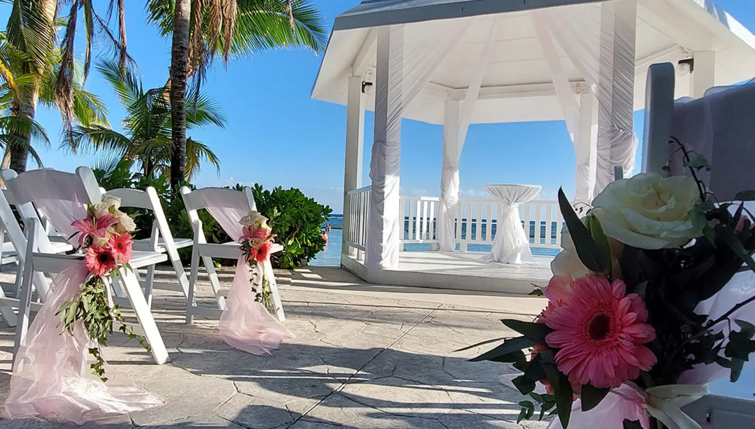 Chair decoration details set on white gazebo at El dorado Seaside suites