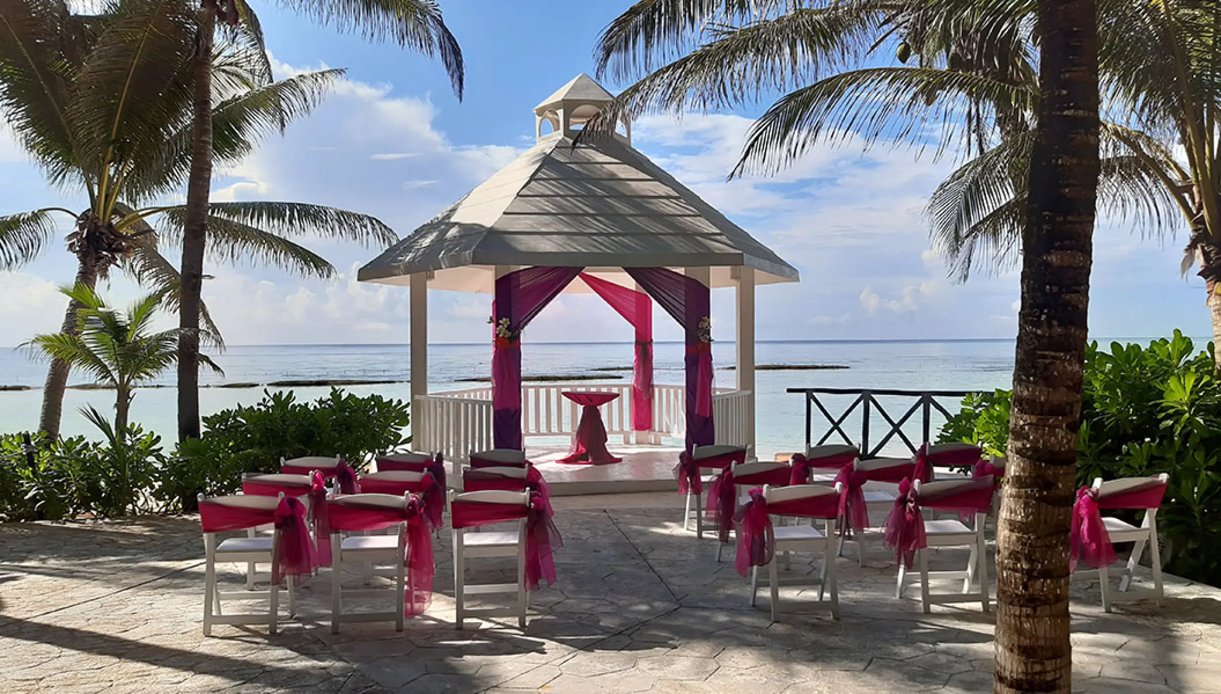 White gazebo wedding venue at El dorado Seaside suites