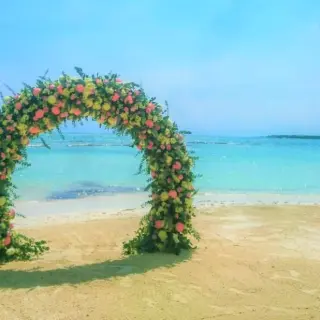 Floral beach ceremony arch at El Dorado Maroma, Riviera Maya