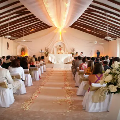 Indoor chapel wedding ceremony with guests and floral arrangements at El Dorado Maroma, Riviera Maya