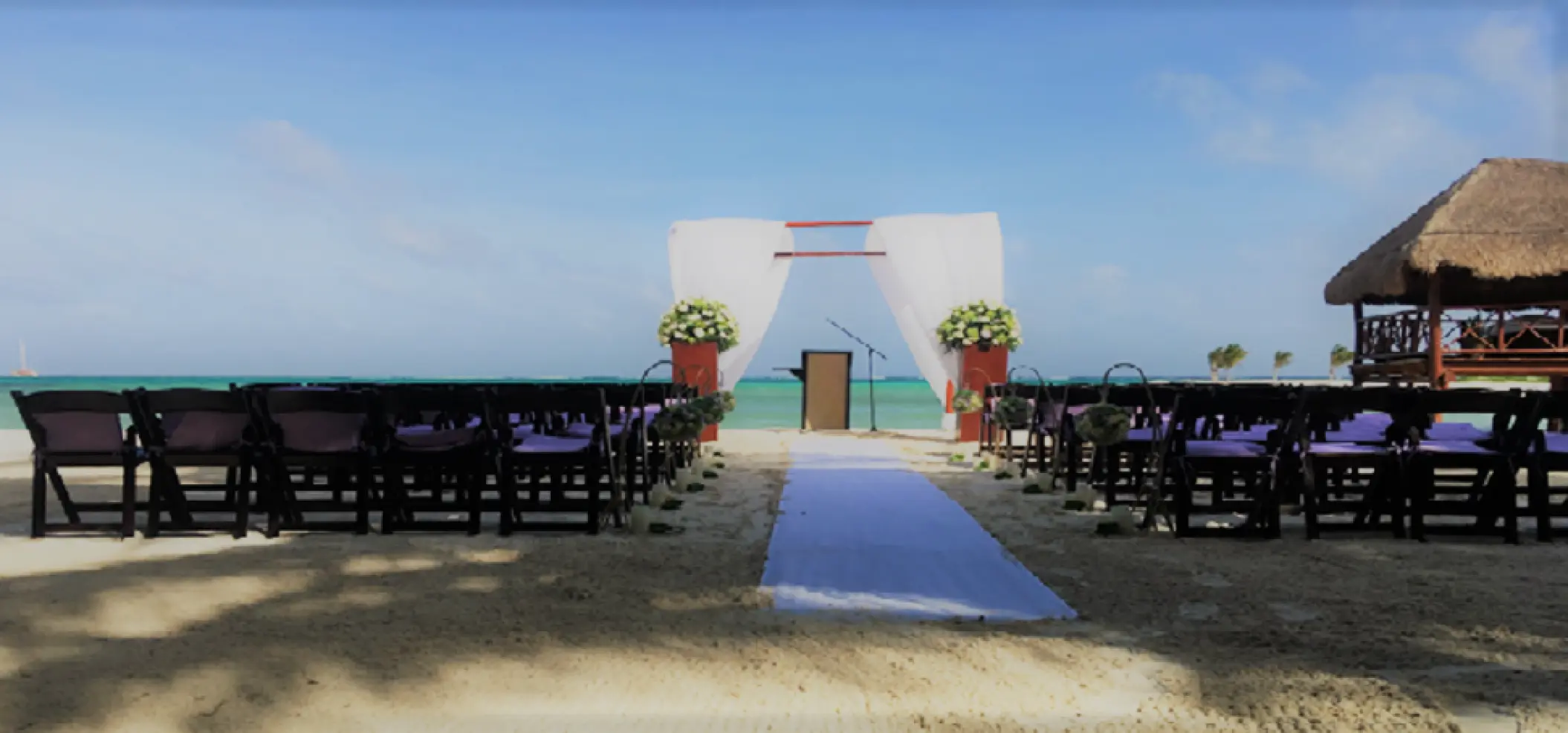 Beachfront wedding ceremony setup at El Dorado Maroma, Riviera Maya