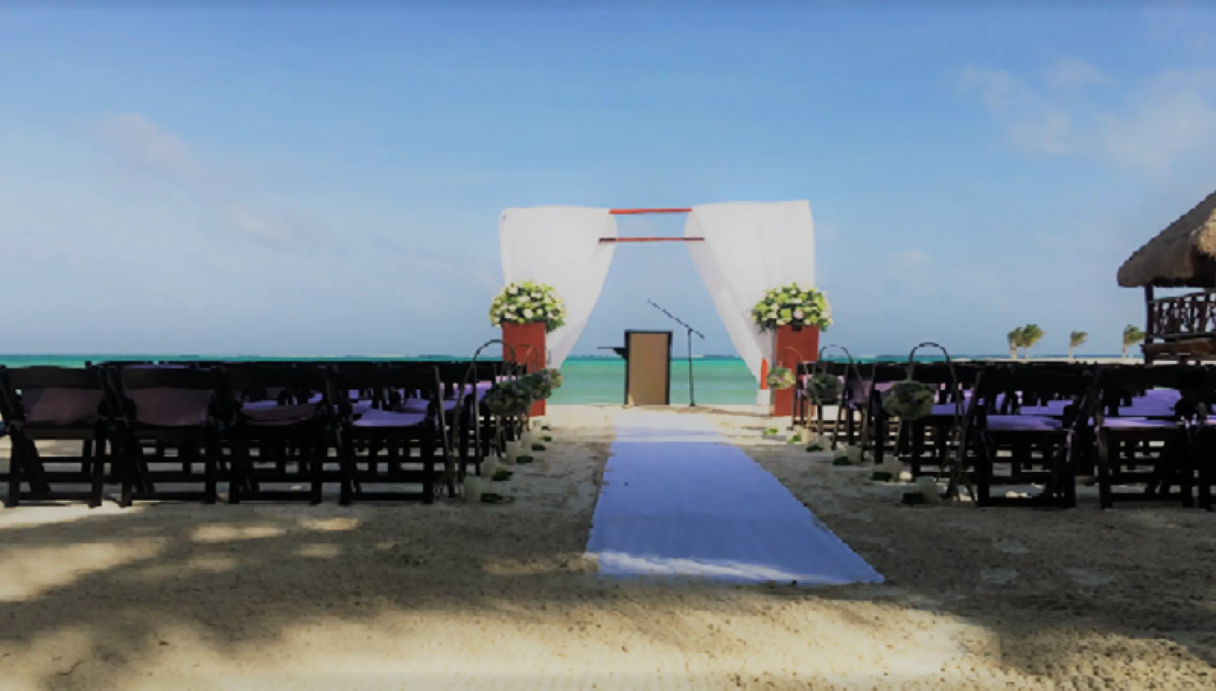 Beachfront wedding ceremony setup at El Dorado Maroma, Riviera Maya