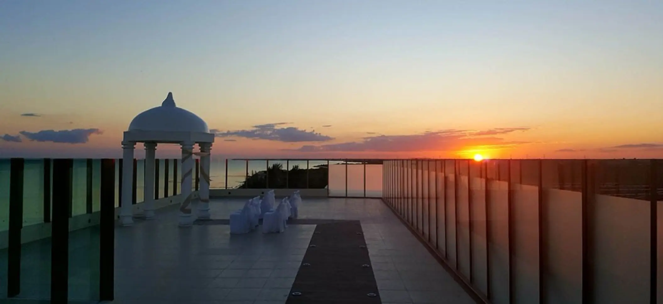 Sky deck wedding ceremony setup at sunset at El Dorado Maroma, Riviera Maya