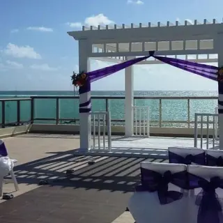 Sky deck wedding ceremony with purple accents at El Dorado Maroma, Riviera Maya