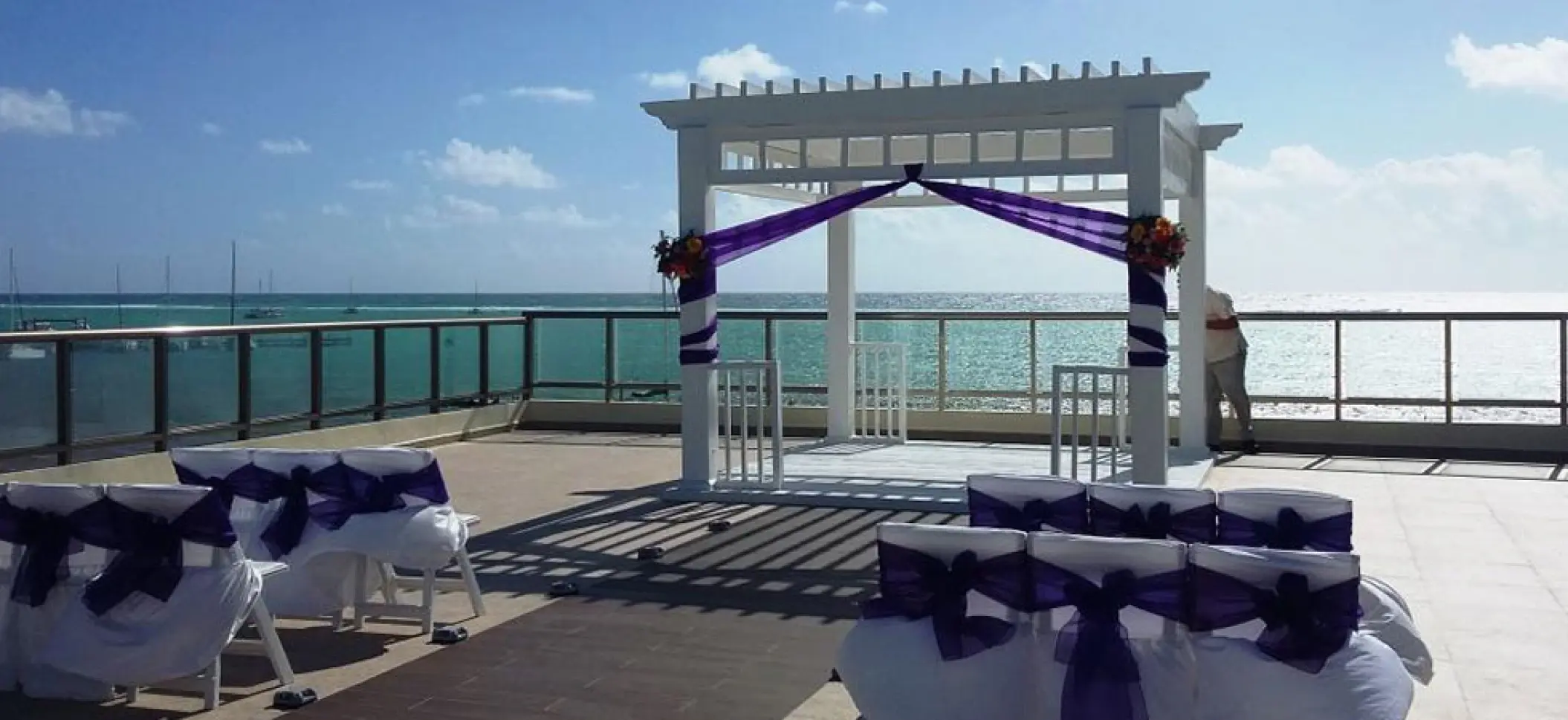Sky deck wedding ceremony with purple accents at El Dorado Maroma, Riviera Maya
