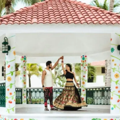 Couple dancing in a white tiled kiosk during a wedding at El Dorado Royale, Riviera Maya